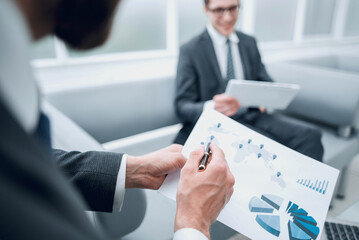 close up.the businessman analyzes the business document