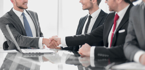 handshake of business partners at a meeting in the office