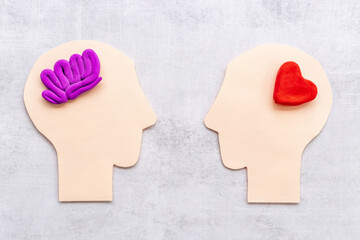 Brain and heart. Logic and emotion communication concept with two paper heads