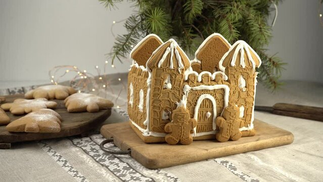 Gingerbread house Christmas homemade baking. Gingerbread Man. astle with white icing. Cookies in the shape of a Christmas tree and snowflakes on the table. Food for dessert. Winter gingerbread.