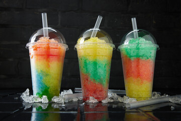 Assortment of various slush drinks in a row