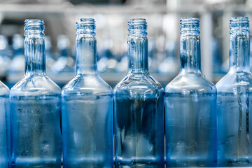 Alcohol beverage factory. Bottles on conveyor belt of bottle filling machine