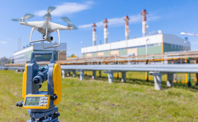 Industry control level and inspection chimneys power plant roof. Drone and laser optical theodolite on tripod equipment for work surveyor