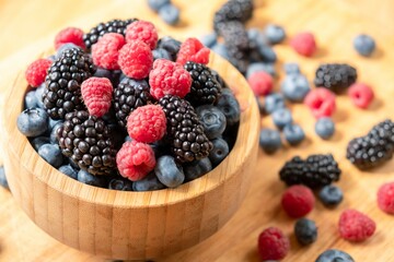 Food healthy blueberry berry organic. nature fruit. Blueberries, raspberries, blackberries in a wooden bowl.