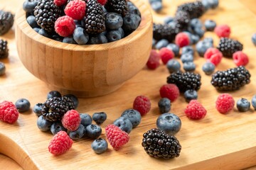 Food healthy blueberry berry organic. nature dessert. Blueberries, raspberries, blackberries in a wooden bowl.