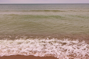 Sea waves crash on the shore.