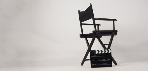 Black director chair and Black Clapper board or movie slate on white background..