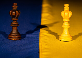 Chess pieces on the yellow blue flag of ukraine. The concept of russian Ukrainian war, escalation, military conflict 2022. Conflict, battle, economic strategy, military policy. Close up.