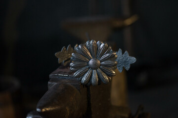 a flower with petals and a stamen, made of metal