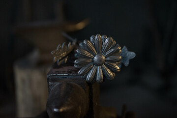 a flower with petals and a stamen, made of metal
