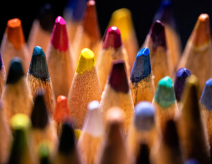 Background of colorful sharpened colored pencils. Multicolored wooden pencils close up. Stationery...