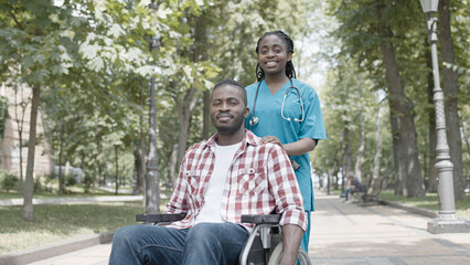 Portrait of smiling female doctor and male patient outdoors, qualified medical care