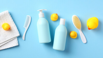 Daily baby care products for bathing on blue background. Baby shampoo bottle, body wash gel, body...