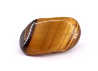 Tiger eye gemstone on white background. Brown yellowish color.