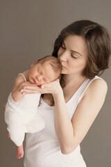 Newborn baby in mother's arms. Postcard Mother's Day. Children Protection Day. World Happiness Day. Smiling child and woman.