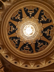 Interior of glossy golden cupola ceiling in opera house