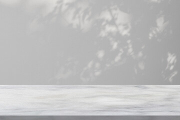 Fototapeta premium Marble table with tree shadow drop on white wall background for mockup product display