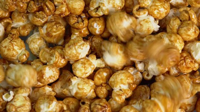 Coffee taste popcorn falls close up. Caramel popcorn. Healthy food for morning breakfast. Healthy breakfast concept. High quality 4k footage