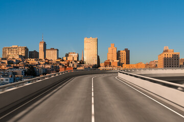 Fototapeta premium Empty urban asphalt road exterior with city buildings background. New modern highway concrete construction. Concept way to success. Transportation logistic industry fast delivery. San Francisco. USA.