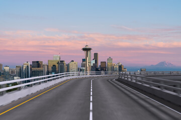 Obraz premium Empty urban asphalt road exterior with city buildings background. New modern highway concrete construction. Concept way to success. Transportation logistic industry fast delivery. Seattle. USA.