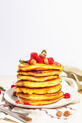 Classic homemade American pancakes with frozen raspberries, hazelnut and mint. Healthy breakfast
