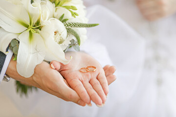 wedding rings on hands of bride