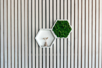 White wooden hexagon shelf on wooden wall.