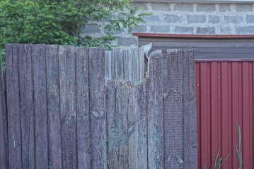 gray broken wooden plank old wall fence a rural street