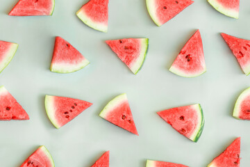 Watermelon seamless pattern. Sliced watermelon on green background. Top view