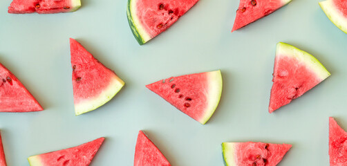 Summer banner. Sliced watermelon on green background.