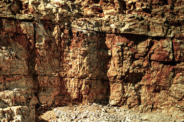 Grungy cragged bumpy pitted cavity stone facade, split layer gap.Ruined cracked shattered worn rough hiking canyon.Old ragged grunge steep marble cliff. Grand vintage crannied damaged impressive gorge