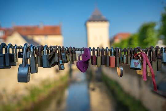 A love locks attached to the mesh, padlocks on the bridge in the city of Valkenburg in Provice Limburg, selective focus