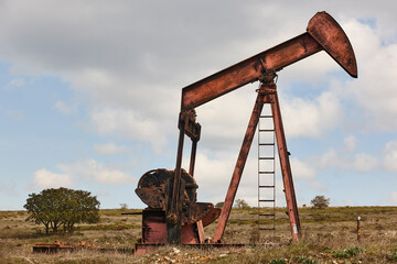 Oil pumping machine. Pump jack. Petroleum extraction. Global warming
