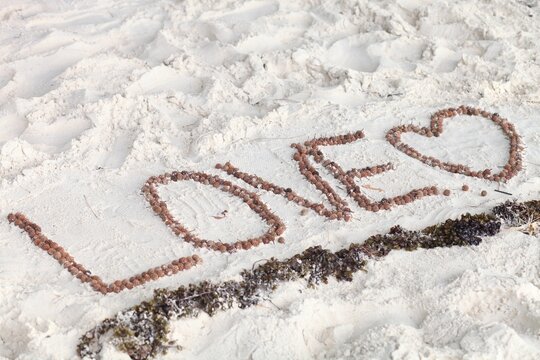 romantic inscription on the sand love. High quality photo