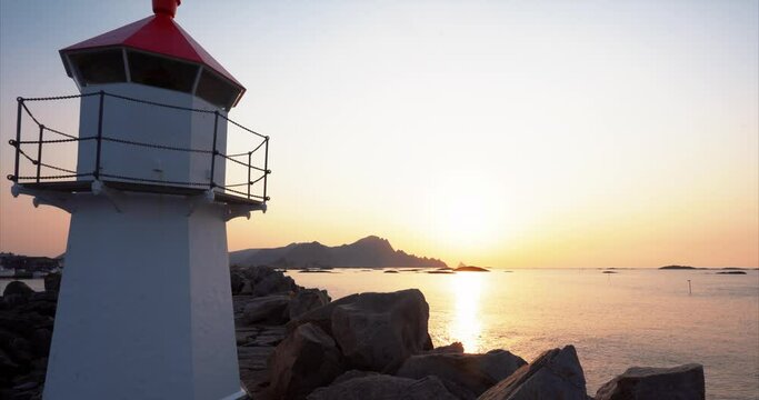 Small lighthouse, sunset view to coastline of Andoya, lofoten, norway