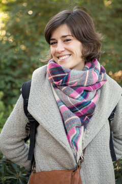 vertical portrait of a happy woman in a park
