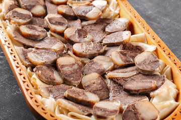 Closeup on kazakh national dish beshbarmak on gray background