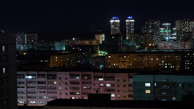 Panoramic: Flickering light in the windows of high-rise apartment buildings