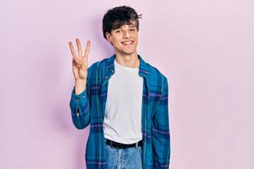 Handsome hipster young man wearing casual white t shirt and vintage shirt showing and pointing up with fingers number three while smiling confident and happy.