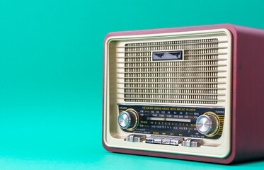 Brown and gold antique radio isolated on blue background with copy space