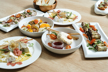 Homemade cheese with sun-dried tomatoes. With pesto sauce and olive oil.