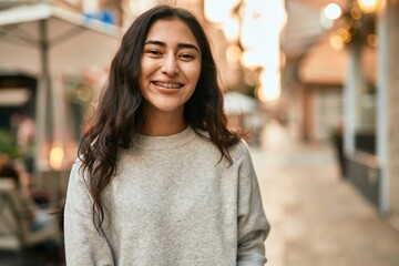 Young middle east girl smiling happy standing at the city.