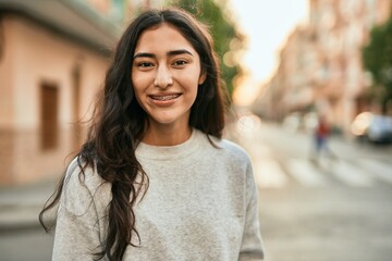 Young middle east girl smiling happy standing at the city.