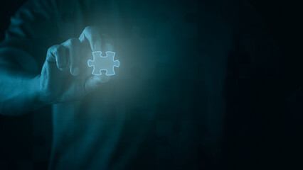 Young businessman holding a puzzle in his hand, Business solutions.