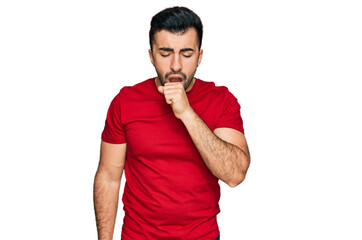 Hispanic man with beard wearing casual red t shirt feeling unwell and coughing as symptom for cold or bronchitis. health care concept.