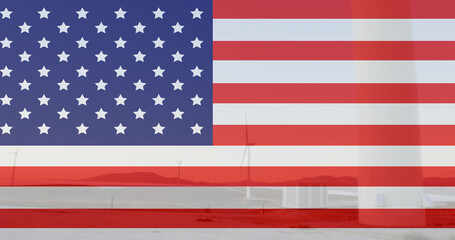 Image of flag of usa over wind turbine