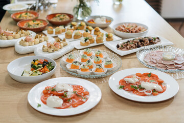 Beautifully decorated catering banquet table with different food snacks and appetizers with sandwich
