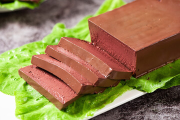slice of coagulated duck blood on table