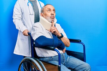 Handsome senior man with beard sitting on wheelchair with neck collar thinking concentrated about doubt with finger on chin and looking up wondering