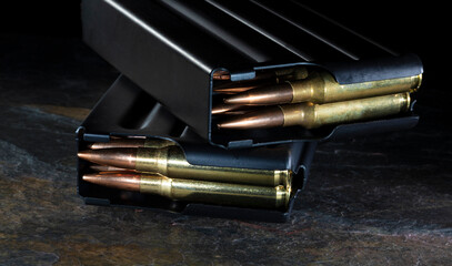Fototapeta premium Two metal magazines loaded with ammo